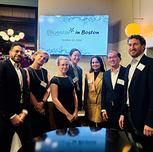 Group of people in business attire gather in social setting for networking event