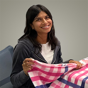 Smiling young woman folding a blank